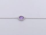 a bracelet with a purple stone on a silver chain
