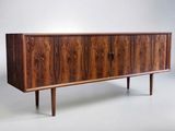the sideboard is made of wood and has three drawers