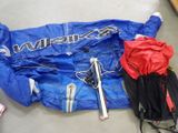 a blue jacket and skis laying on the floor