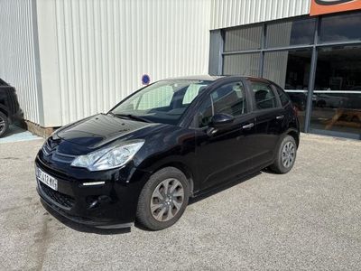the black car is parked in front of a building