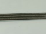 a silver and gold sword on a white surface