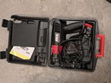 a black and red tool box with a corded cord in it
