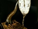 a bronze sculpture of a bird on top of a clock