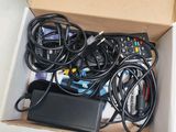 a box full of remote controls and cables in it