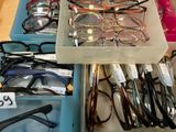 many pairs of glasses on display in a box