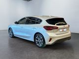 the rear end of a white car in a showroom
