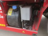 a red truck with an air compressor on the back of it