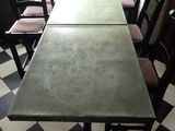tables and chairs in a restaurant with black and white checkered floor
