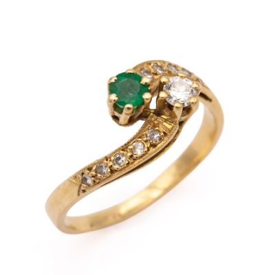 a close up of a gold ring with a green and white stone