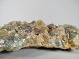 yellow and green crystals on a white surface with a white background