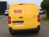 a yellow van that is parked in a parking lot