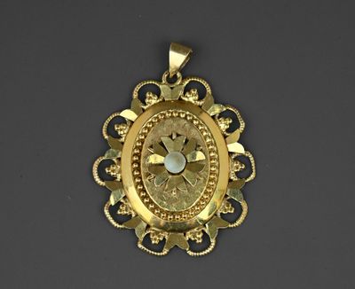 an image of a gold pendant with a clock in the center