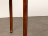 the table is made of teak and has four legs