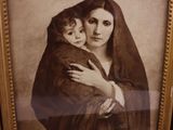 an old picture of a woman holding a child in her arms