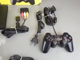 two controllers and a charger sitting on a table