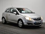 the silver opel is parked in a room with a checkered floor