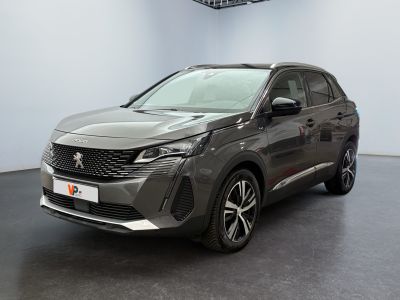 a grey car is parked in a room with a black floor