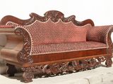 a wooden bench that is sitting on the sidewalk