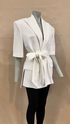 a mannequin wearing a white jacket and black leggings