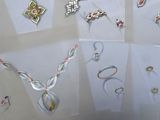 many different types of jewelry on display in a display case