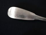 a silver spoon with a spoon handle on a black surface