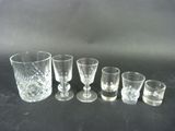several glasses are lined up in a row on a table