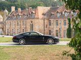 a black sports car parked in front of a large building