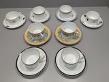 nine cups and saucers sitting on a table