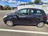 a picture of a small black car parked in a parking lot