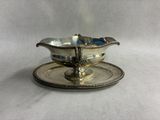 a silver plate with a saucer on top of it