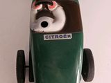 a green toy car with a dog on the front
