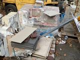 a pile of junk on the ground next to a forklift