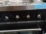 a black oven that has four burners on top of it