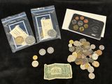 some coins and a card are sitting on a black table