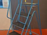 a blue ladder that is on the floor in a room
