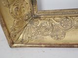 a picture of a gold picture frame on a white table