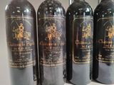 four bottles of wine are lined up on a table