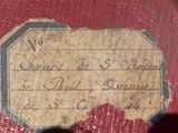 a label on the back of an old red car