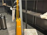 a yellow hand truck that is parked in a warehouse