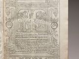 an open book with a picture of a man and woman in a garden