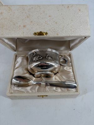 a silver plate with spoons and spoon rest in a box