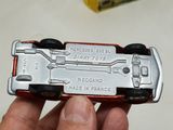 a person holding a toy car in their hand