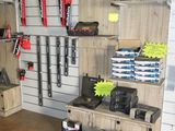 many tools hanging on the wall in this garage