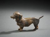 figurine of a dachshund dog on a gray surface
