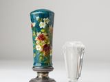a vase and a glass sitting on a table
