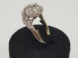 a close up of a diamond ring sitting on top of a black box
