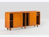 the sideboard is made of teak and has a sliding door