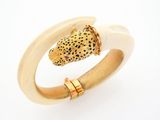 an image of a gold and white ring with a leopard head on it