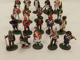 many figurines of soldiers on a white surface