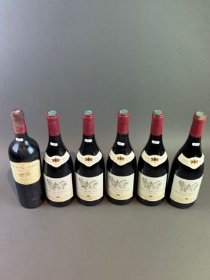 six bottles of wine lined up in a row on a table